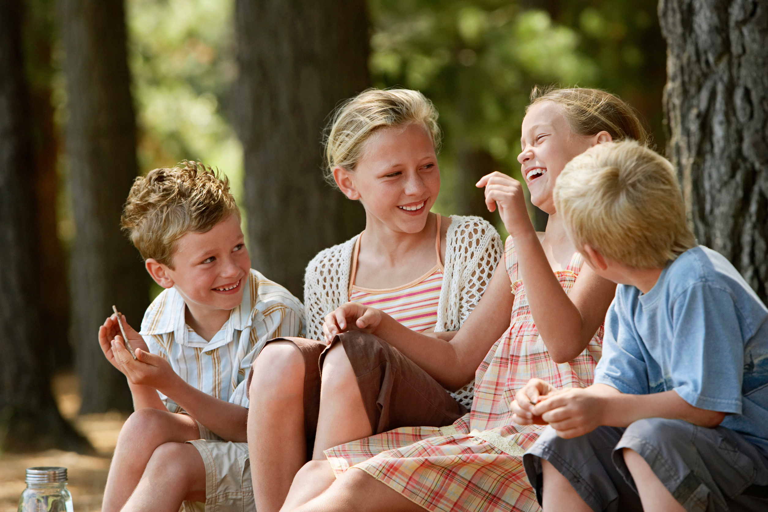 Cheerful Children Sitting In Forest